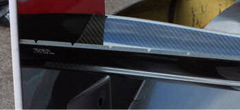 Serated gurney flap on rear wing