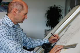 Adrian Newey behind drawing board